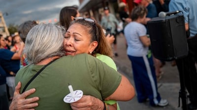 Community members embrace during a candlelight vigil to honor the lives lost in the flash floods that claimed more than 120 lives on July 11, 2025 in Kerrville, Texas. (Getty Images via AFP) Community members embrace during a candlelight vigil to honor the lives lost in the flash floods that claimed more than 120 lives on July 11, 2025 in Kerrville, Texas. (Getty Images via AFP)