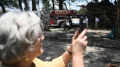 White House chief of staff Susie Wiles takes pictures as US President Donald Trump (3rd R), Texas Governor Greg Abbott (2nd L) and First Lady Melania Trump (L) meet with local officials and first responders as they visit an area near the Guadalupe River following devastating flooding that ocurred in the area over the July 4 weekend, in Kerrville, Texas, on July 11, 2025. (AFP) White House chief of staff Susie Wiles takes pictures as US President Donald Trump (3rd R), Texas Governor Greg Abbott (2nd L) and First Lady Melania Trump (L) meet with local officials and first responders as they visit an area near the Guadalupe River following devastating flooding that ocurred in the area over the July 4 weekend, in Kerrville, Texas, on July 11, 2025. (AFP)