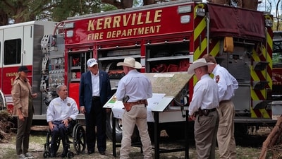 Trump, first lady Melania Trump and Texas Governor Greg Abbott meet with local emergency services personnel as they survey flood damage along the Guadalupe River on July 11, 2025 in Kerrville, Texas. (Getty Images via AFP) Trump, first lady Melania Trump and Texas Governor Greg Abbott meet with local emergency services personnel as they survey flood damage along the Guadalupe River on July 11, 2025 in Kerrville, Texas. (Getty Images via AFP)