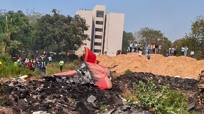 People look at the debris of the Air India plane that crashed moments after taking off from the airport, in Ahmedabad on June 12. (PTI) People look at the debris of the Air India plane that crashed moments after taking off from the airport, in Ahmedabad on June 12. (PTI)