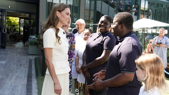 Kate meets Shaniah Williams and Jefferson Iweh as she arrives to attend the women's singles final between Poland's Iga Swiątek and Amanda Anisimova of the US at the Wimbledon Tennis Championships in London, Saturday, July 12, 2025. (Jordan Pettitt/Pool via AP)(AP)