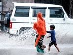 A mother with her two kids crosses the road amid rain and splashes, in Rajasthan's Bikaner.
A mother with her two kids crosses the road amid rain and splashes, in Rajasthan's Bikaner.