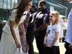 Britain's Kate Middleton, Princess of Wales meets Lydia Lowe, eight, from the Dan Maskell Tennis Trust, as she arrives to attend the Ladies' Singles Final of the 2025 Wimbledon Championships at the All England Lawn Tennis and Croquet Club, London, Britain. Picture date: Saturday July 12, 2025.    Jordan Pettitt/Pool via REUTERS