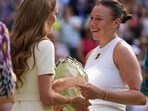 Amanda Anisimova of the U.S. receives her runners-up trophy from Kate, Princess of Wales, after losing to Poland's Iga Swiatek during the women's single final at the Wimbledon Tennis Championships in London, Saturday, July 12, 2025. (AP Photo/Kin Cheung)