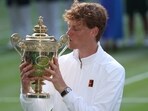 Jannik Sinner celebrates with the trophy after winning the men's Wimbledon final against Carlos Alcaraz.