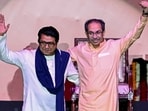 Shiv Sena (UBT) chief Uddhav Thackeray (R) and his cousin and Maharashtra Navnirman Sena (MNS) president Raj Thackeray gesture as they greet the crowd upon their arrival on stage to address a joint rally against the imposition of the Hindi language in primary schools, in Mumbai on July 5, 2025.