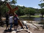 A cross is placed by the Guadalupe River across from Camp Mystic in Hunt, Texas