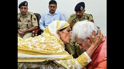 A family member of a terror attack victim kisses the forehead of Jammu and Kashmir LG Manoj Sinha during distribution of job letters to family members of the victims, in Baramulla, on Sunday. (PTIR) A family member of a terror attack victim kisses the forehead of Jammu and Kashmir LG Manoj Sinha during distribution of job letters to family members of the victims, in Baramulla, on Sunday. (PTIR)