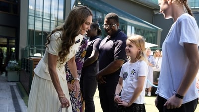 Britain's Kate Middleton, Princess of Wales meets Lydia Lowe, eight, from the Dan Maskell Tennis Trust, as she arrives to attend the Ladies' Singles Final of the 2025 Wimbledon Championships at the All England Lawn Tennis and Croquet Club, London, Britain. Picture date: Saturday July 12, 2025.    Jordan Pettitt/Pool via REUTERS (via REUTERS)