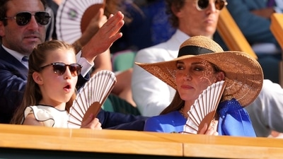 Kate and Princess Charlotte use a fan as they watch Jannik Sinner of Italy and Carlos Alcaraz of Spain during their men's singles final match at the Wimbledon Tennis Championships in London, Sunday, July 13, 2025.(AP Photo/Kirsty Wigglesworth) (AP) Kate and Princess Charlotte use a fan as they watch Jannik Sinner of Italy and Carlos Alcaraz of Spain during their men's singles final match at the Wimbledon Tennis Championships in London, Sunday, July 13, 2025.(AP Photo/Kirsty Wigglesworth) (AP)
