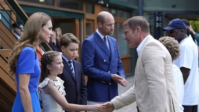 William wore a sophisticated double-breasted navy suit with a matching pocket square and tie, while Kate donned a sleek blue dress with a necklace. For the formal event, Prince George was likewise dressed in a dapper suit and tie. (AP)