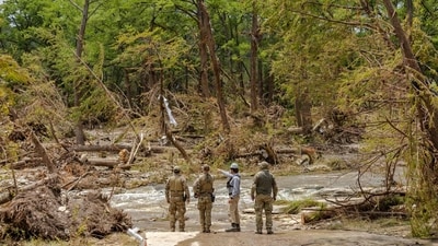 Crews scout out locations to send a cadaver dog team during continued search and recovery operations on the bank of the Guadalupe River (Getty Images via AFP) Crews scout out locations to send a cadaver dog team during continued search and recovery operations on the bank of the Guadalupe River (Getty Images via AFP)