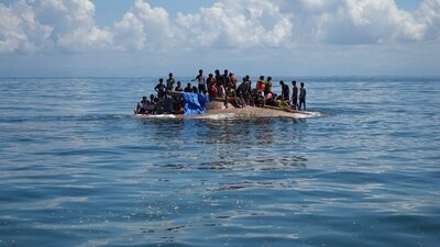 Rohingya refugees are seen on a capsized boat before being rescued in the waters of West Aceh, Indonesia. (REUTERS)