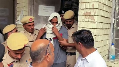 The Father of the deceased Radhika Yadav, accused Deepak Yadav being brought out of the court and taken to a one-day Police remand after the court's order, in Gurugram on Friday. (ANI ) The Father of the deceased Radhika Yadav, accused Deepak Yadav being brought out of the court and taken to a one-day Police remand after the court's order, in Gurugram on Friday. (ANI )