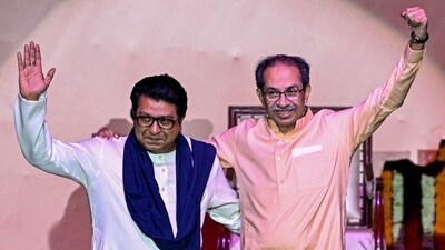 Shiv Sena (UBT) chief Uddhav Thackeray (R) and his cousin and Maharashtra Navnirman Sena (MNS) president Raj Thackeray gesture as they greet the crowd upon their arrival on stage to address a joint rally against the imposition of the Hindi language in primary schools, in Mumbai on July 5, 2025. (AFP) Shiv Sena (UBT) chief Uddhav Thackeray (R) and his cousin and Maharashtra Navnirman Sena (MNS) president Raj Thackeray gesture as they greet the crowd upon their arrival on stage to address a joint rally against the imposition of the Hindi language in primary schools, in Mumbai on July 5, 2025. (AFP)
