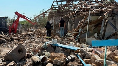 This handout photograph taken and released by Ukrainian State Emergency Service on July 13, 2025, shows rescuers clearing debris to find the body of a female local resident killed at the site of a burnt private house, following a Russian guided aerial bomb attack in Velykomykhaylivka village, Dnipropetrovsk region. (AFP) This handout photograph taken and released by Ukrainian State Emergency Service on July 13, 2025, shows rescuers clearing debris to find the body of a female local resident killed at the site of a burnt private house, following a Russian guided aerial bomb attack in Velykomykhaylivka village, Dnipropetrovsk region. (AFP)