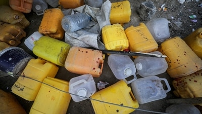 Blood stains some containers at the site of an Israeli strike that killed Palestinians, gathered to collect water from a distribution point, according to medics, in the central Gaza Strip. (Reuters)