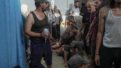 Palestinians injured during Israeli airstrikes receive treatment on the floor at Shifa Hospital in Gaza City. (AP) Palestinians injured during Israeli airstrikes receive treatment on the floor at Shifa Hospital in Gaza City. (AP)