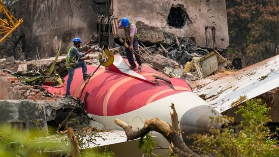 Wreckage of the crashed Air India plane being lifted by a crane, in Ahmedabad, Gujarat, on June 14. (PTI)