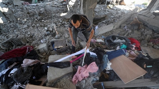 A Palestinian inspects the site of an overnight Israeli strike on a house, in Gaza City.(Reuters)