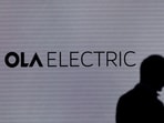 A man walks past the logo of Ola Electric during a press conference ahead of it's IPO launch in Mumbai, India, July 29, 2024. 