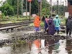 Workers clear railway tracks amid waterlogging due to the recent heavy rainfall, at a railway station at Jamshedpur, in East Singhbhum district, Jharkhand.