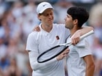 Italy's Jannik Sinner reacts with Spain's Carlos Alcaraz after winning the Wimbledon final.