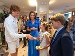 Tennis - Wimbledon - All England Lawn Tennis and Croquet Club, London, Britain - July 13, 2025 Italy's Jannik Sinner with the trophy alongside Britain's Catherine, Princess of Wales, Princess Charlotte and Prince George after winning the men's final against Spain's Carlos Alcaraz Pool via Reuters/Andrew Parsons