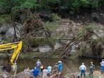 Members of a search and rescue team look for missing people amid debris in the waters of the Guadalupe River, near Camp Mystic, following deadly flooding (REUTERS/Umit Bektas)