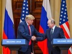 US President Donald Trump and Russia's President Vladimir Putin shake hands before attending a joint press conference..