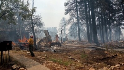 A firefighter stands near smoldering debris and active flames amid the charred remains of a burned structure near the Grand Canyon Lodge in Arizona, U.S. July 13, 2025.    National Park Service/Handout via REUTERS    THIS IMAGE HAS BEEN SUPPLIED BY A THIRD PARTY. MANDATORY CREDIT. (via REUTERS)