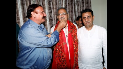 BJP leader and former Jammu and Kashmir deputy CM Kavinder Gupta being offered sweets on being appointed as lieutenant governor of Ladakh, on Monday. (ANI)