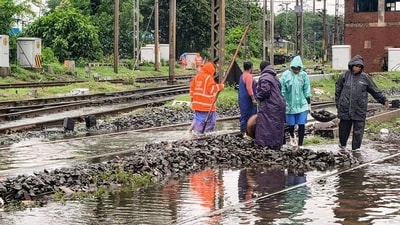 Workers clear railway tracks amid waterlogging due to the recent heavy rainfall, at a railway station at Jamshedpur, in East Singhbhum district, Jharkhand. (PTI FILE) Workers clear railway tracks amid waterlogging due to the recent heavy rainfall, at a railway station at Jamshedpur, in East Singhbhum district, Jharkhand. (PTI FILE)