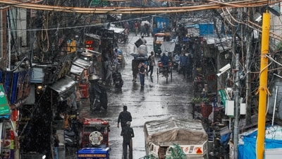 People at a street near the Jama Masjid during rain, in New Delhi (PTI/Shahbaz Khan)