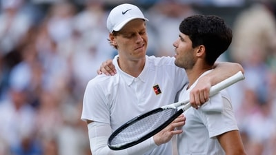Italy's Jannik Sinner reacts with Spain's Carlos Alcaraz after winning the Wimbledon final. (REUTERS)