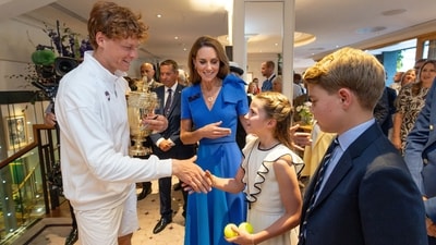 Tennis - Wimbledon - All England Lawn Tennis and Croquet Club, London, Britain - July 13, 2025 Italy's Jannik Sinner with the trophy alongside Britain's Catherine, Princess of Wales, Princess Charlotte and Prince George after winning the men's final against Spain's Carlos Alcaraz Pool via Reuters/Andrew Parsons (Pool via Reuters)