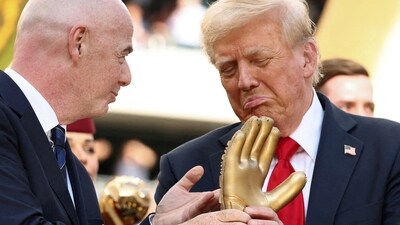 U.S. President Donald Trump looks at the golden glove trophy next to FIFA president Gianni Infantino after Chelsea won against Paris St Germain in the FIFA Club World Cup final, at the MetLife Stadium in East Rutherford, New Jersey, U.S., July 13, 2025. REUTERS/Kevin Lamarque/Pool (REUTERS)
