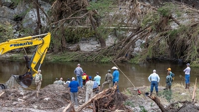 Members of a search and rescue team look for missing people amid debris in the waters of the Guadalupe River, near Camp Mystic, following deadly flooding (REUTERS/Umit Bektas) (REUTERS)