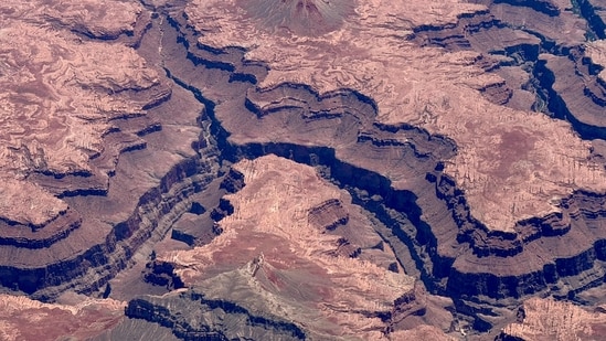 &nbsp;This aerial view taken on July 7, 2025 shows part of the Grand Canyon in Arizona, including several bends of the Colorado River. Spreading wildfires forced the evacuation on July 11, 2025, of part of the famed Grand Canyon, with the US National Park Service appealing for visitors to stay calm. The canyon's North Rim, which is less popular with tourists than the South Rim, was being cleared due to a blaze called the White Sage Fire. (Photo by Daniel SLIM / AFP)(AFP)