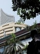 FILE PHOTO: Men walk past a screen displaying market results outside the Bombay Stock Exchange (BSE) in Mumbai, India (REUTERS)