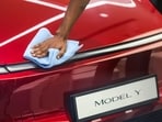 A worker gives a wipe-down to a Tesla Model Y electric car at the company's first India showroom, at Bandra Kurla Complex (BKC) in Mumbai, on Tuesday, July 15.