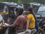 People travelling during heavy rain in Mumbai's Andheri.