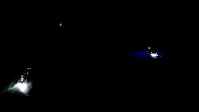 Motorboats flash lights on the Axiom SpaceX Dragon spacecraft after spotting it afloat on the Pacific Ocean. (Video grab/Axiom Space) Motorboats flash lights on the Axiom SpaceX Dragon spacecraft after spotting it afloat on the Pacific Ocean. (Video grab/Axiom Space)