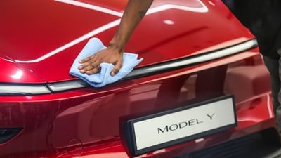 A worker gives a wipe-down to a Tesla Model Y electric car at the company's first India showroom, at Bandra Kurla Complex (BKC) in Mumbai, on Tuesday, July 15. (Dhiraj Singh/Bloomberg) A worker gives a wipe-down to a Tesla Model Y electric car at the company's first India showroom, at Bandra Kurla Complex (BKC) in Mumbai, on Tuesday, July 15. (Dhiraj Singh/Bloomberg)