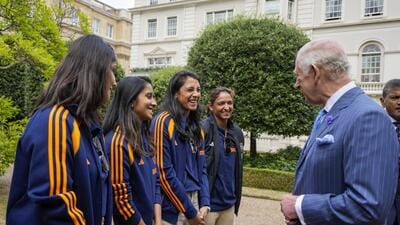 King Charles III interacts with Indian women’s cricket team. (PTI) King Charles III interacts with Indian women’s cricket team. (PTI)