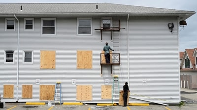 Workers installed plywood at the rear of the Gabriel House Assisted Living Facility after the deadly fire in Massachusetts. (Reuters)