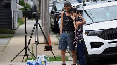 Donna Corvelo of Fall River is consoled by her husband, Tony Corvelo, outside the assisted living facility, where her uncle Bob King, died in fire. (Reuters)