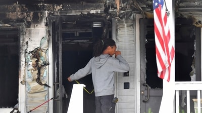 Investigators took measurements near the entrance to the Gabriel House assisted living facility following a fire that started late Sunday. (AP) Investigators took measurements near the entrance to the Gabriel House assisted living facility following a fire that started late Sunday. (AP)