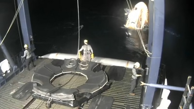 Operation personnel pull the Dragon spacecraft closer to the floating jetty, to make way for the deboarding of the crew. (Video Grab/Axiom Space) Operation personnel pull the Dragon spacecraft closer to the floating jetty, to make way for the deboarding of the crew. (Video Grab/Axiom Space)