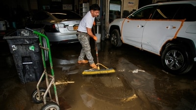 A man cleans a garage affected by heavy flooding in the Elmsford area of Westchester, New York, U.S., July 15, 2025.  REUTERS/Eduardo Munoz (REUTERS)